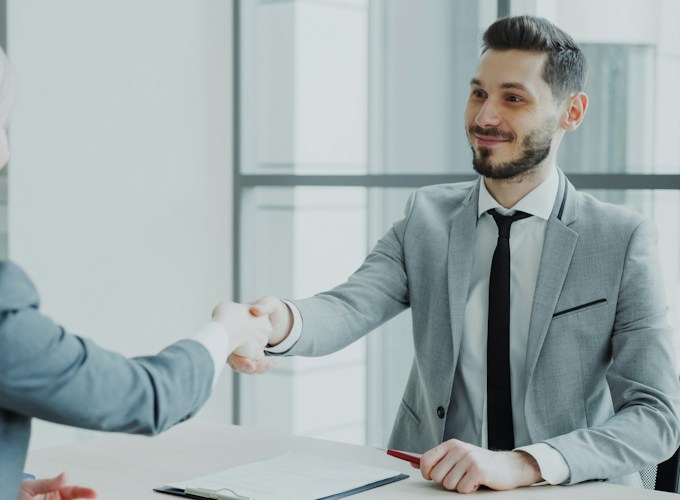 Business owners shaking hands with a local Frisco loan broker